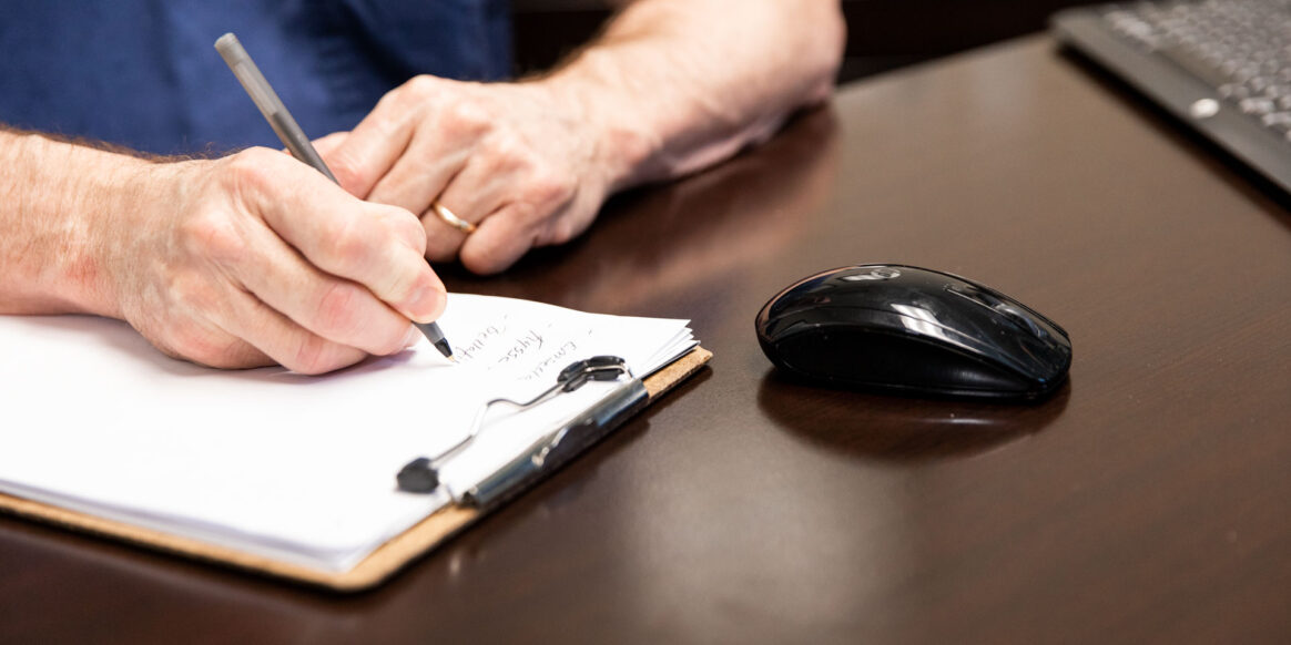 doctor writing on paper