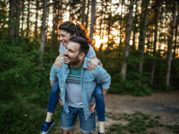 Happy couple having fun in the woods.