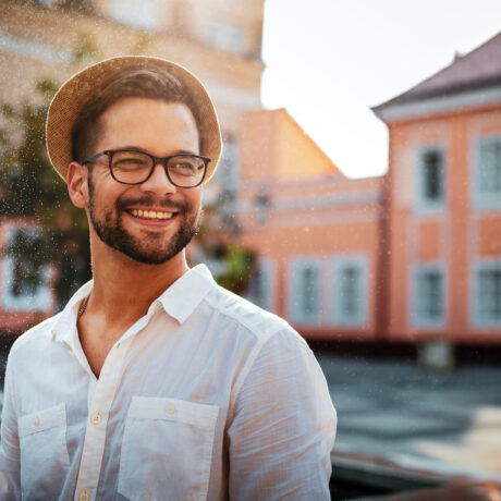 Portrait of handsome young man smiling outdoors