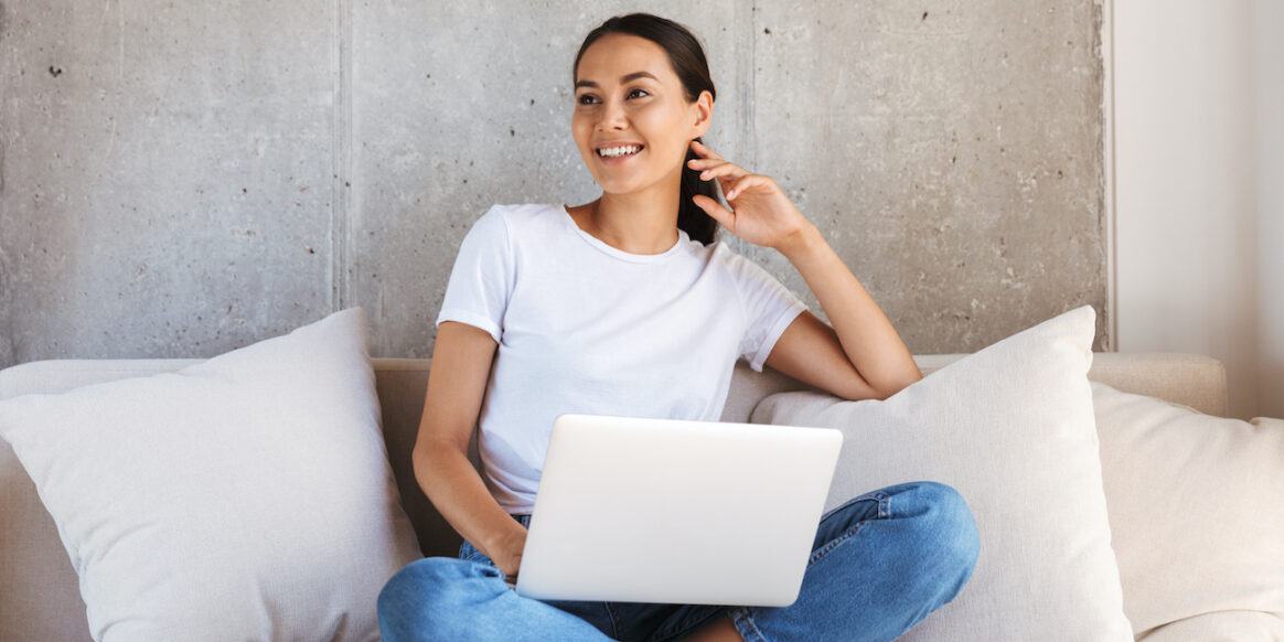 Pretty young asian woman using laptop computer