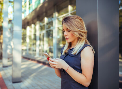 Beautiful woman texting on the mobile phone.